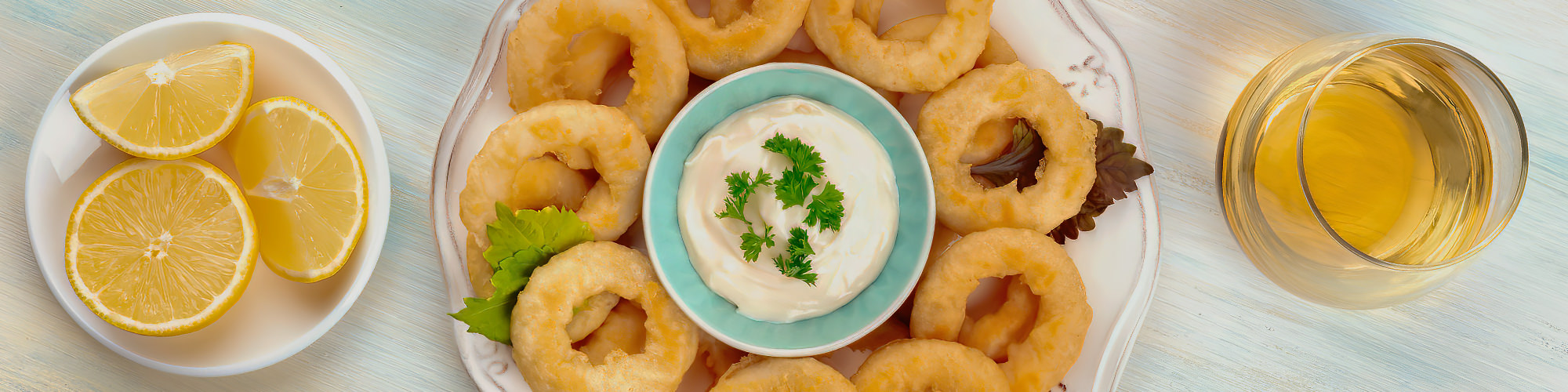 Beautiful golden yellow squid rings with garlic sauce